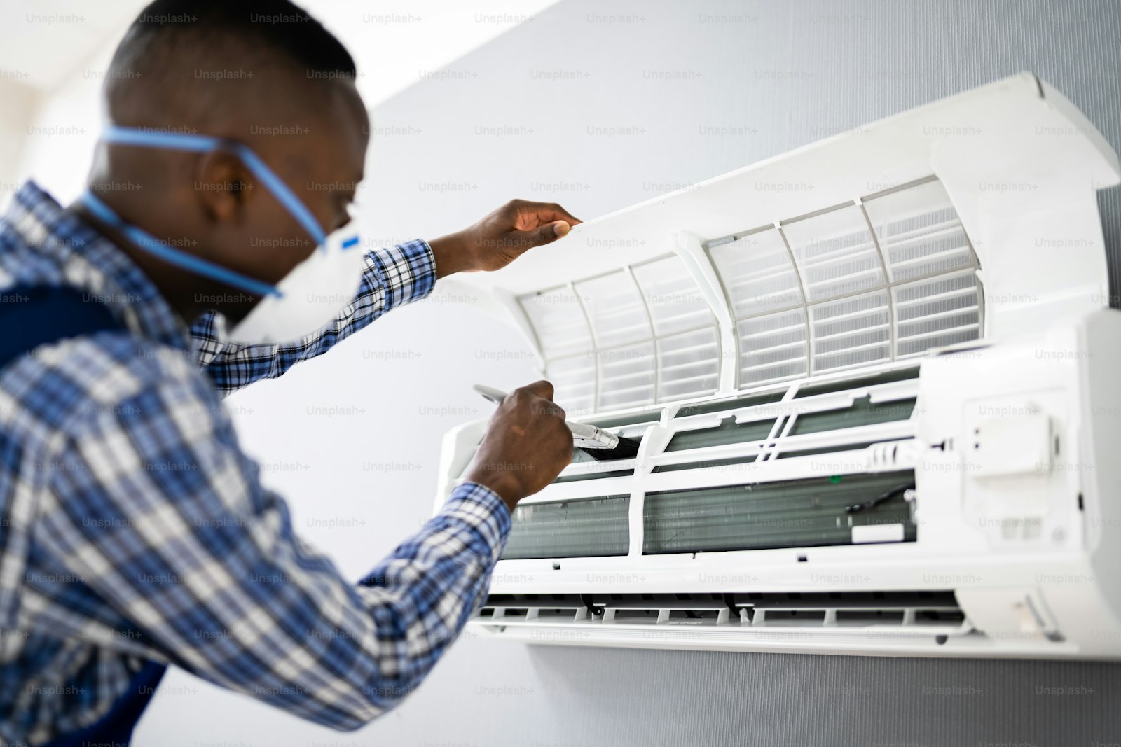 A home comfort technician working near heating and cooling equipment