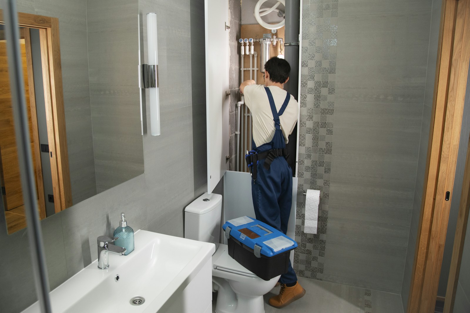 A plumber working on household bathroom plumbing